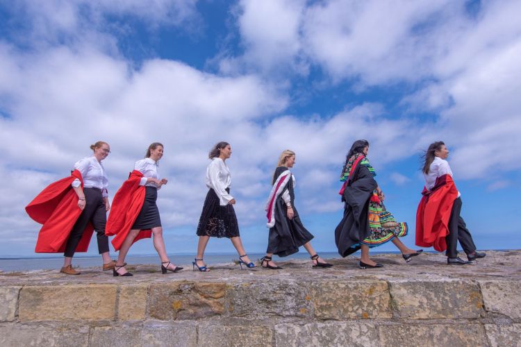 Students walking along the pier